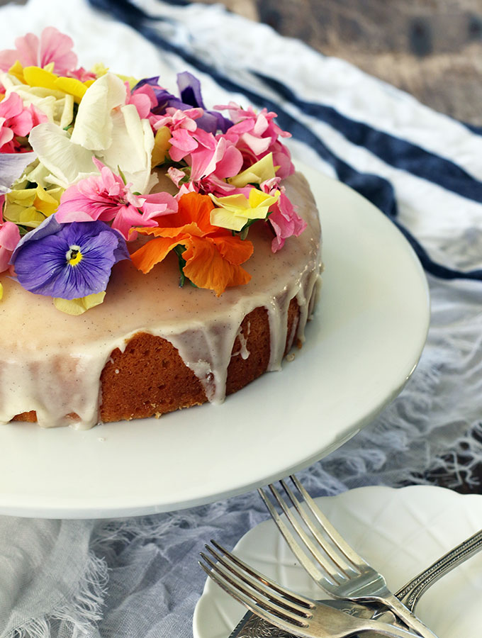 Brandy Butter Cake decorated with vanilla brandy icing and edible flowers