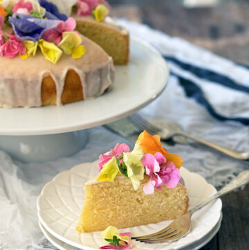 Brandy Butter Cake decorated with vanilla brandy icing and edible flowers