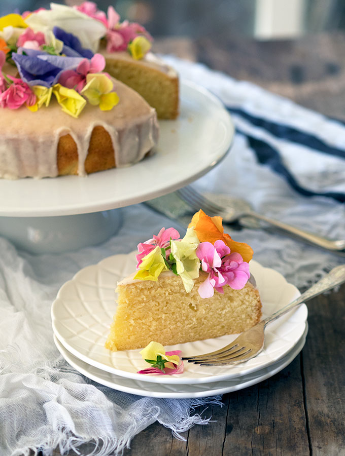 Brandy Butter Cake decorated with vanilla brandy icing and edible flowers