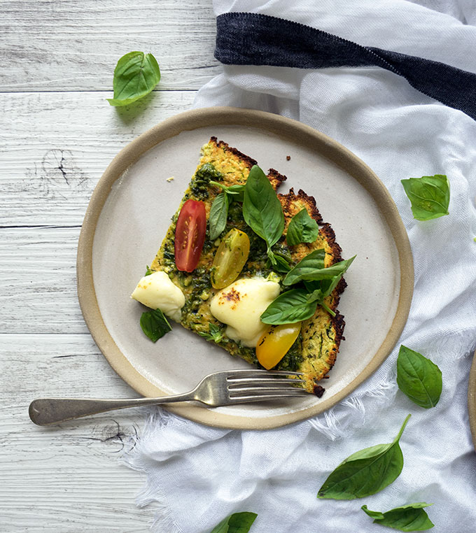 zucchini pizza base recipe with fresh heirloom tomatoes, basil, pesto and mozzarella cheese