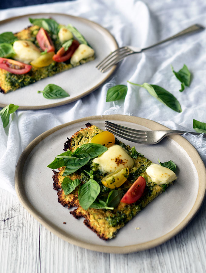 zucchini pizza base recipe with fresh heirloom tomatoes, basil, pesto and mozzarella cheese