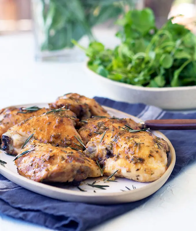 Simple to prepare oven baked skinless chicken thigh cutlets, with sticky maple, garlic and rosemary glaze. Simply Delicious mid week family fare.