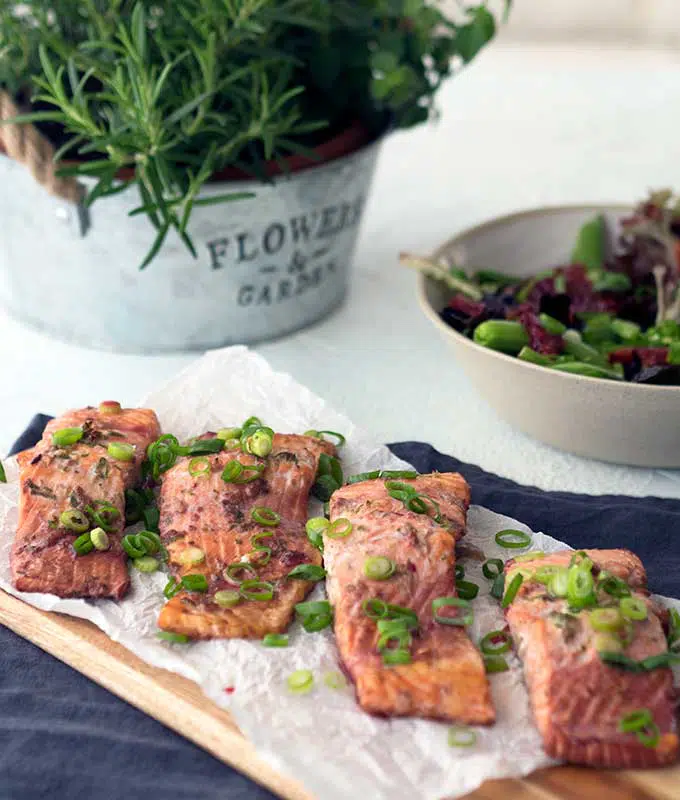 cooked ocean trout fillets with spring onion slices