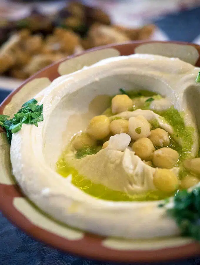 Bowl of creamy hummus with olive oil and chickpeas