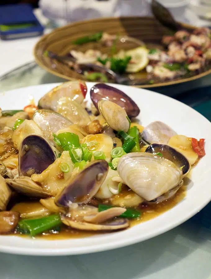 Macanese cuisine wok fried pipis with xo chilli sauce and rice cake