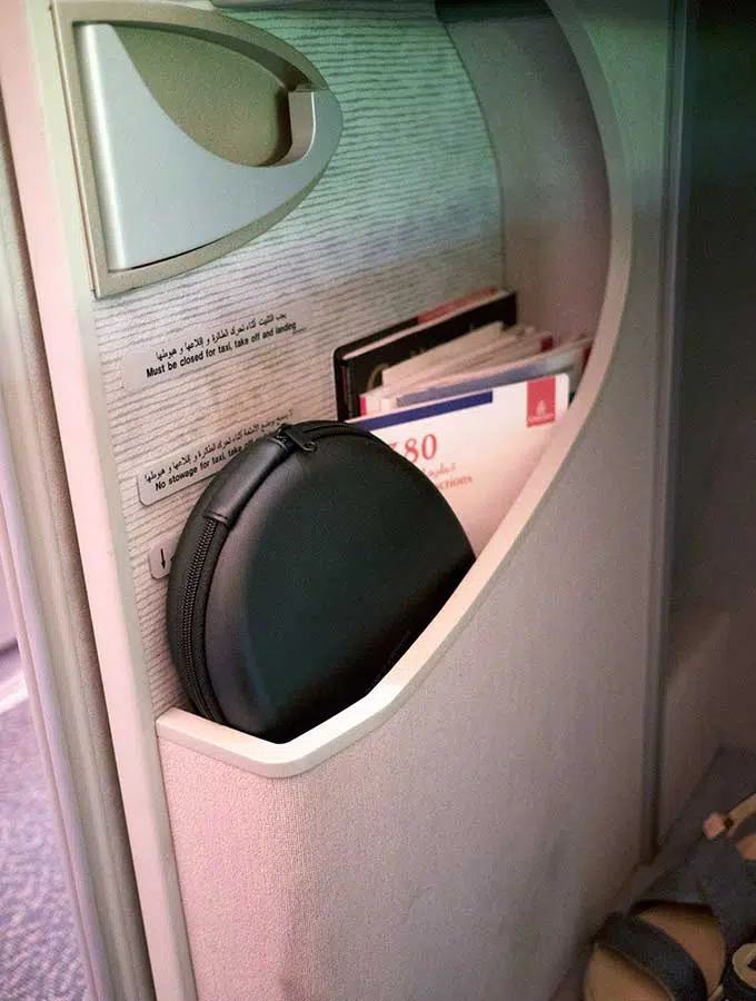 Emirates First Class Sydney to Bangkok magazine and head phone storage in first class suite