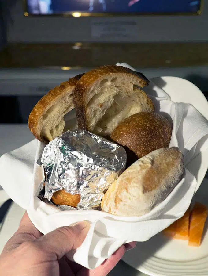 Emirates First Class Sydney to Bangkok bread basket with a variety of breads including garlic bread in foil