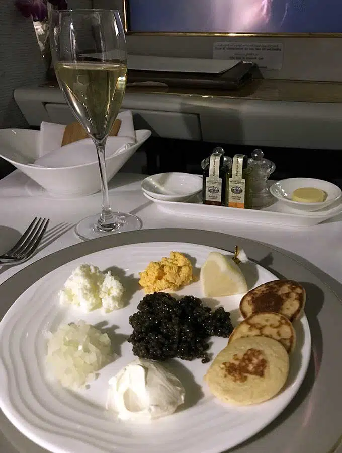 Emirates First Class Sydney to Bangkok caviar course with chopped egg yolk, chopped egg white, chopped onion and blinis