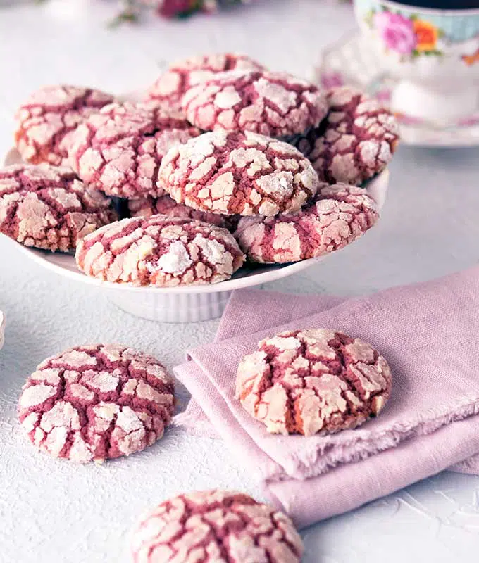 Ruby Chocolate Crackle Cookies with extra on the table with a brush pink linen napkin