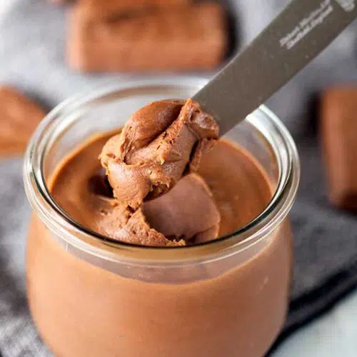 Tim Tam spread in a jar with a knife scooping some out