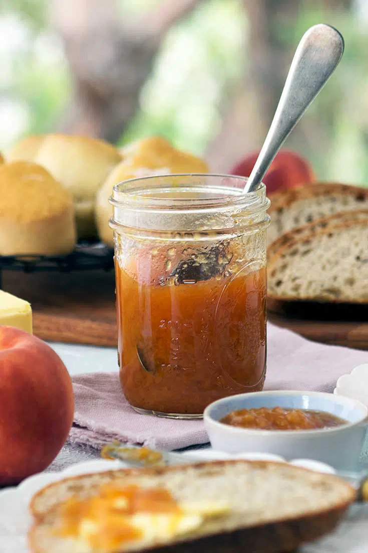 close up of an open jar of peach vanilla bourbon jam