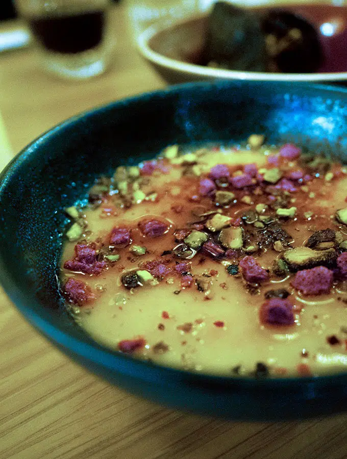 cream caramel with rosewater in a black bowl on a table for iftar during ramadan