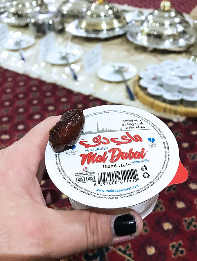 a small container of water with a date sitting on top to break the fast of ramadan