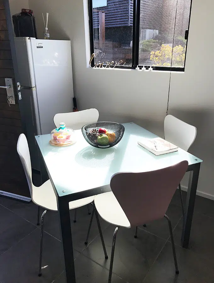 kitchen with table and four chairs and fridge in the back ground, at the dog house port macquarie