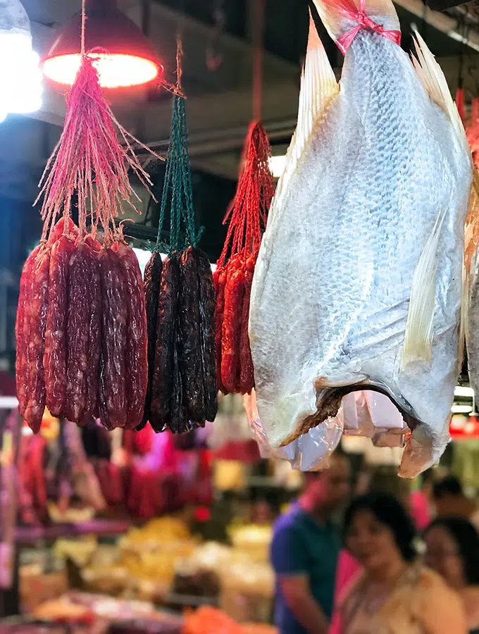 dried chinese sausage and dried fish hanging at a store at the red market macao