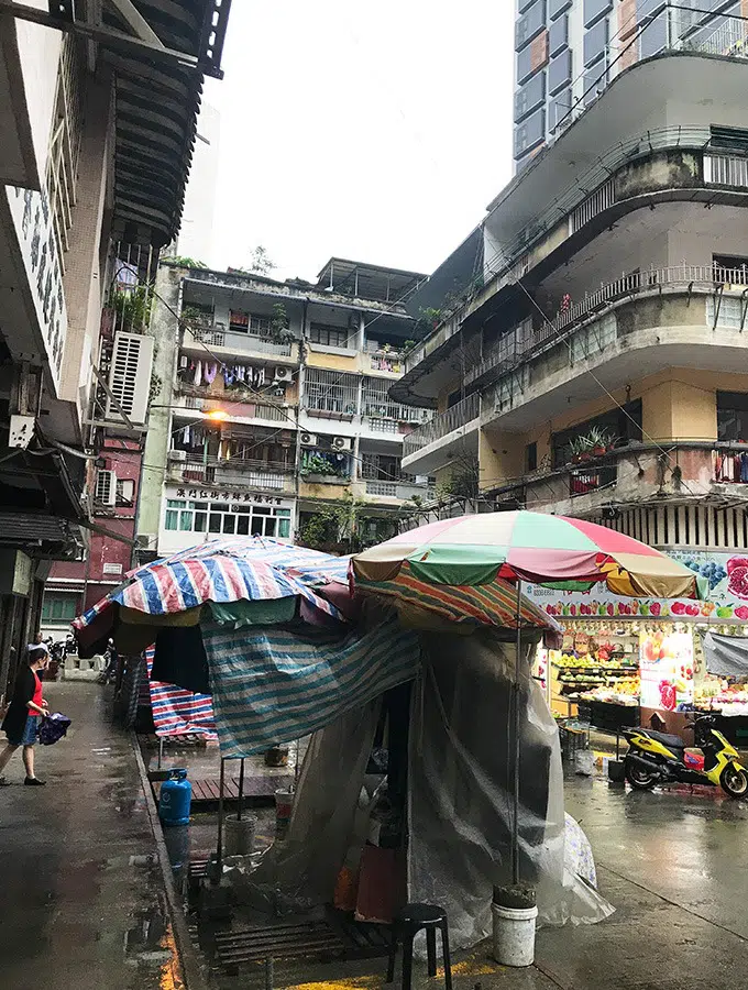 outside market stalls covering up agains the rain outside the red market macao