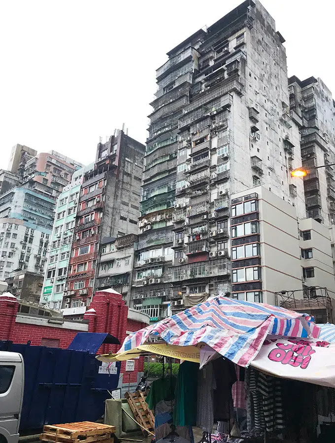 tall grey residential buildings overlooking the red market macao