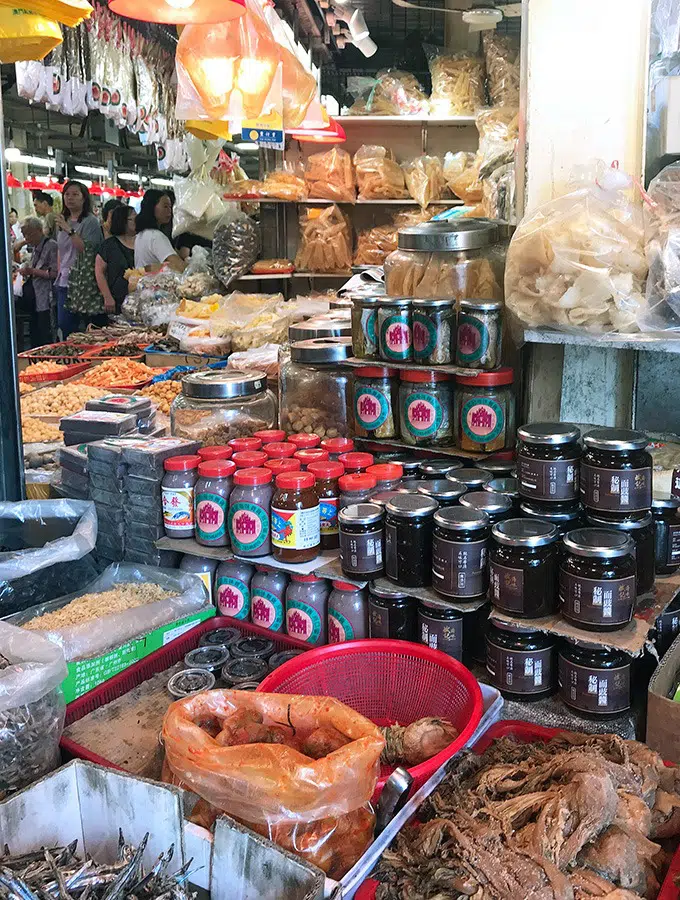 various sauces and dry foods on display at a market stand at the red market macao