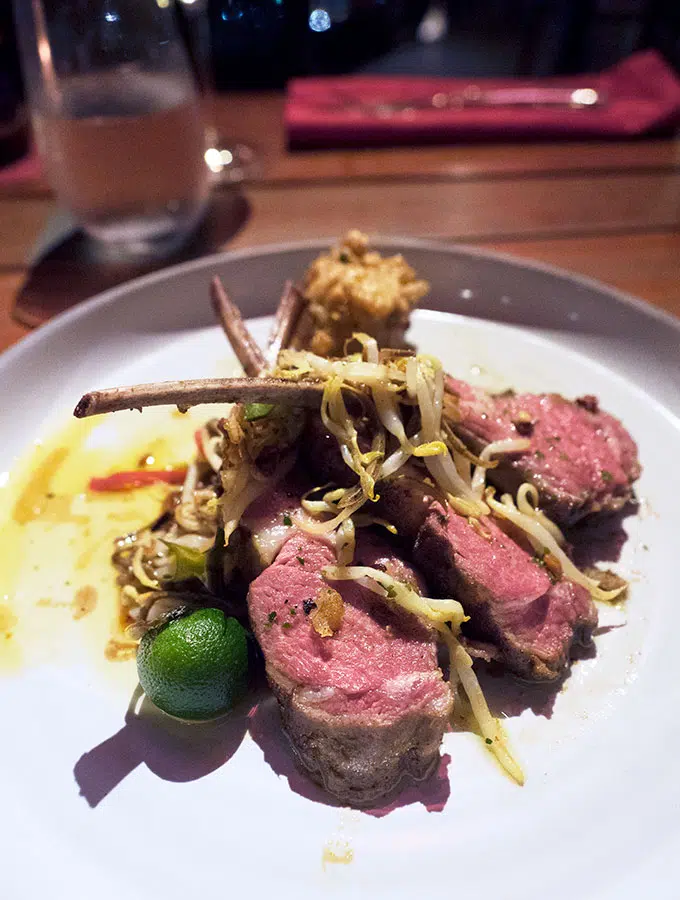 lamb cutlets on a plate with vegetables - Ce La Vi Singapore