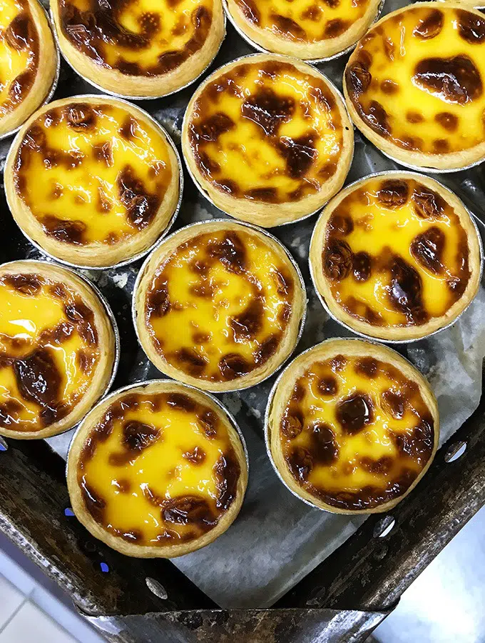 tray of macanese egg tarts straight from the oven