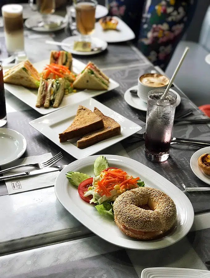 various sandwiches and menu items laid out on a set table