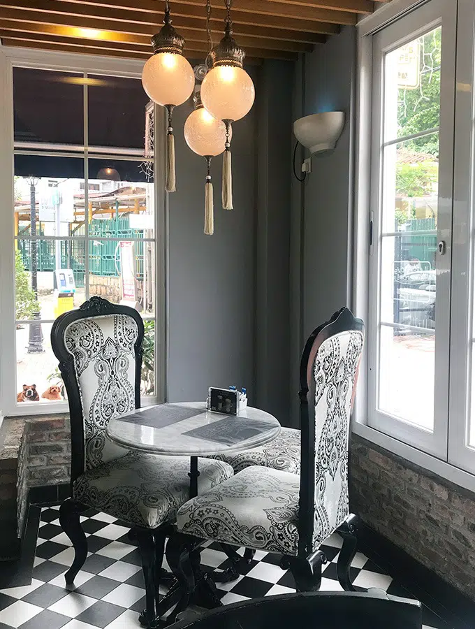 two seats and a table in a window nook of lord stow's cafe