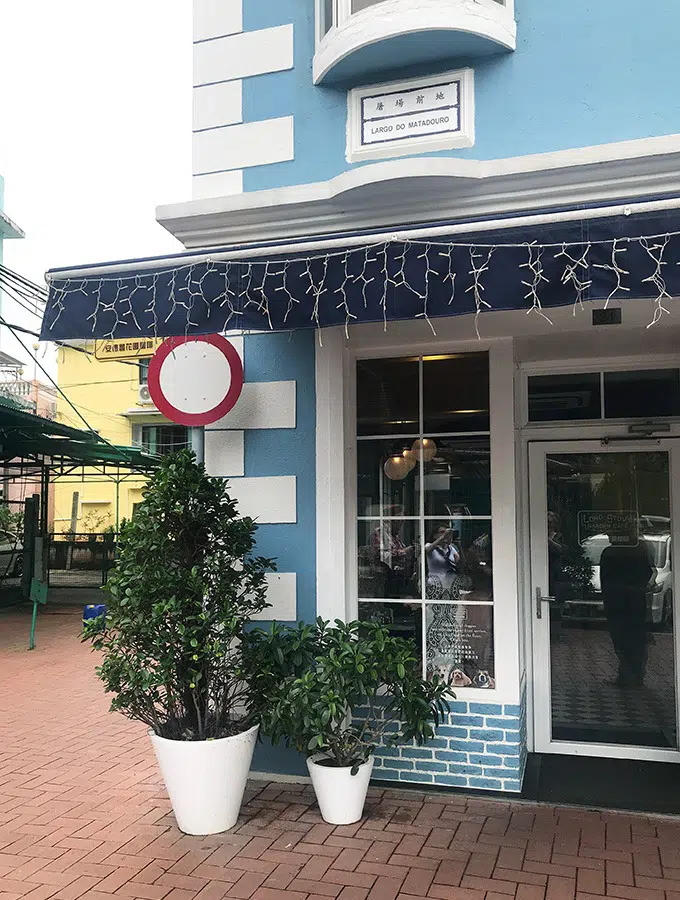 blue and white front of building with glass windows and door