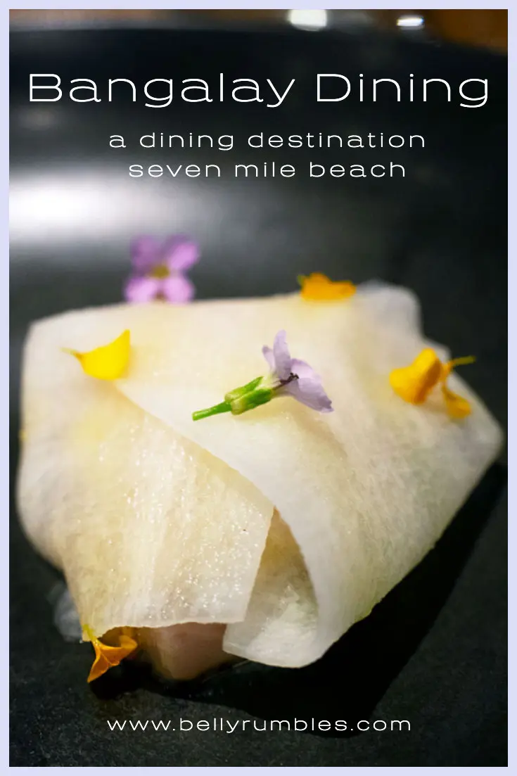 a parcel of mackrel inside ribbons of daikon with flowers on top at bangalay dining