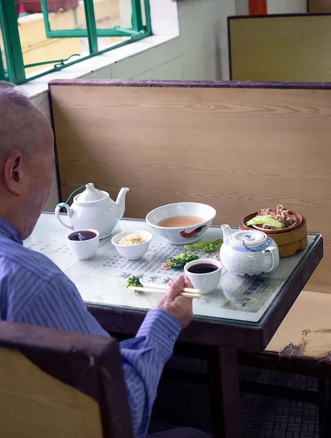 man having tea and dim sum