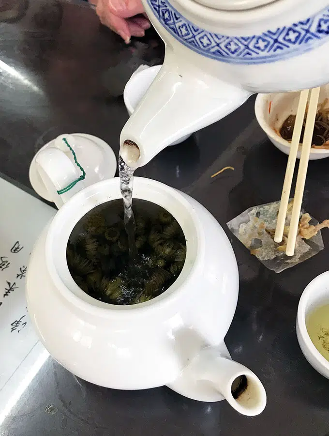 Long Va Tea House in Macao - pouring tea from a tea pot