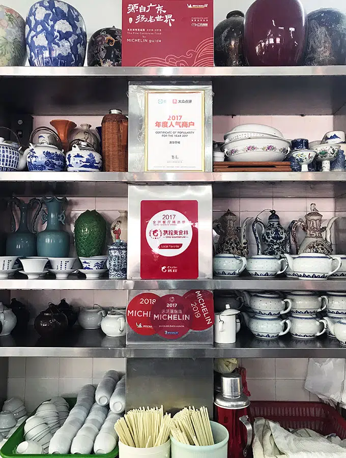 Long Va Tea House in Macao - a selection of tea cups and pots on shelves