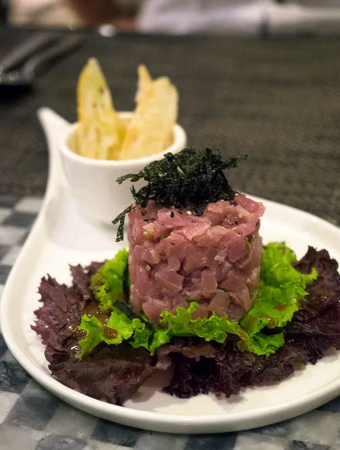 tuna tartare topped with nori and a side of crisp bread