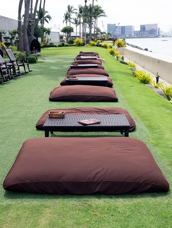 giant pillows on grass with tables at Sofitel Philippine Plaza Manila