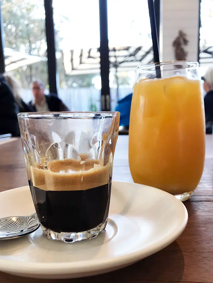 espresso in a glass and an orange juice