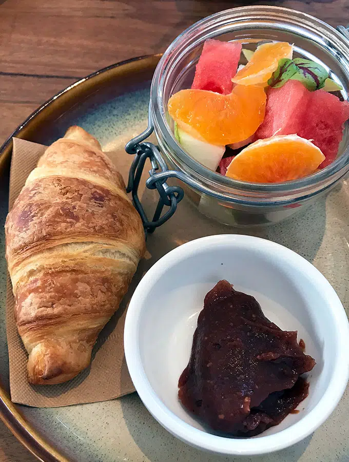 breakfast consisting of mini croissant, fruit salad and quince jam