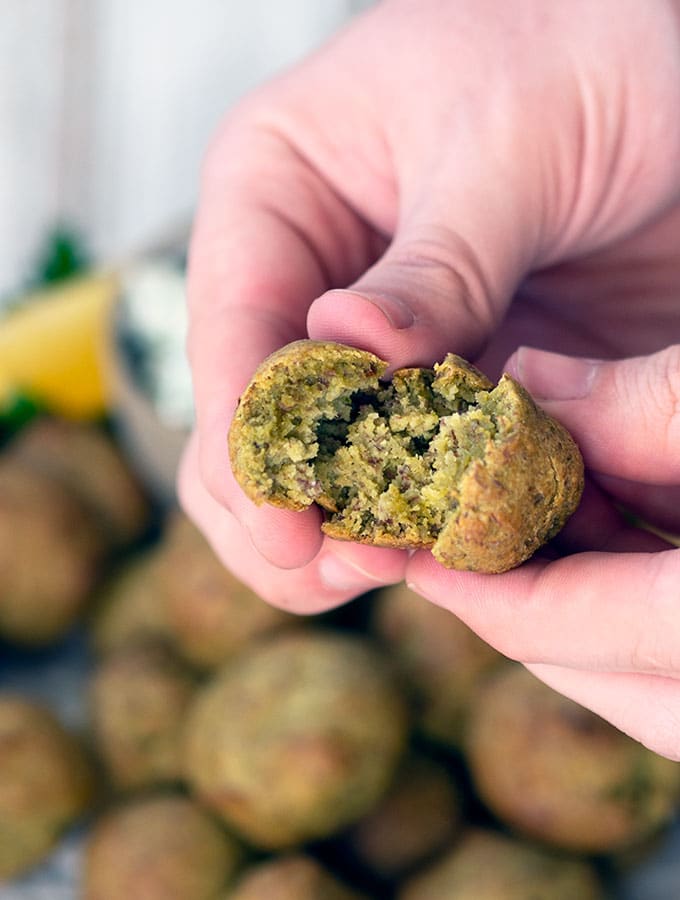 baked falafel being broken to show soft moist centre