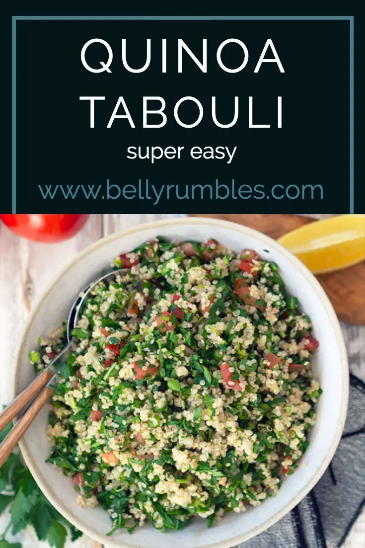 quinoa tabouli in a ceramic bowl with serving spoons