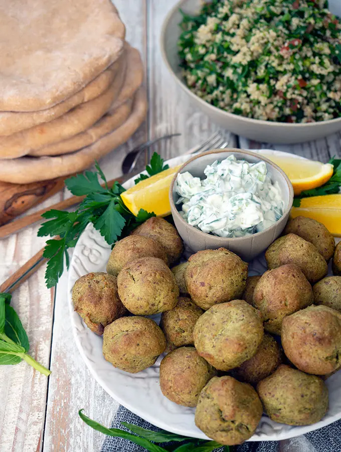 plate with falfel, bowl of tabouli and spelt flat bread