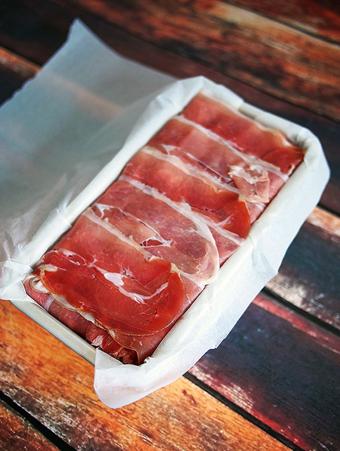 pokr and veal terrine covered with prosciutto ready to be baked in the oven