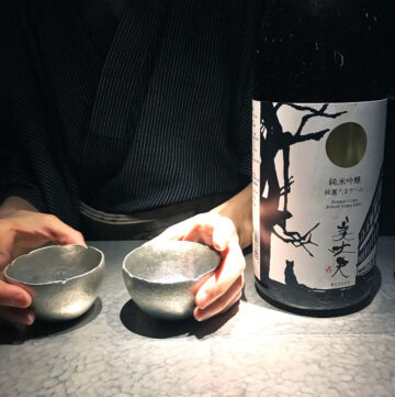 Sake Bar O Tokyo - sake cups being presented by the bar tender next to a bottle of sake
