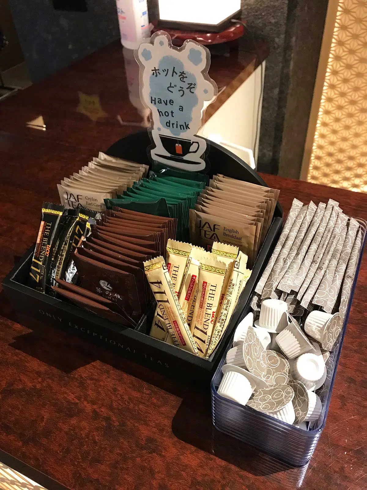 tea, coffee, sugar and milk satchels for guests at hotel reception