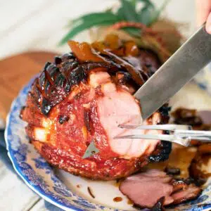 rum and coca cola glazed ham being carved