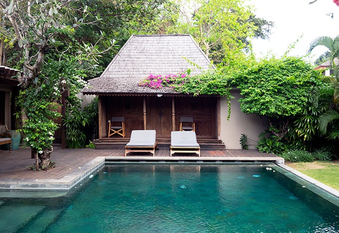 one bedroom cabin with sun lounges in front and pool