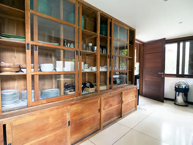 kitchen cabinet filled with plates and utensils