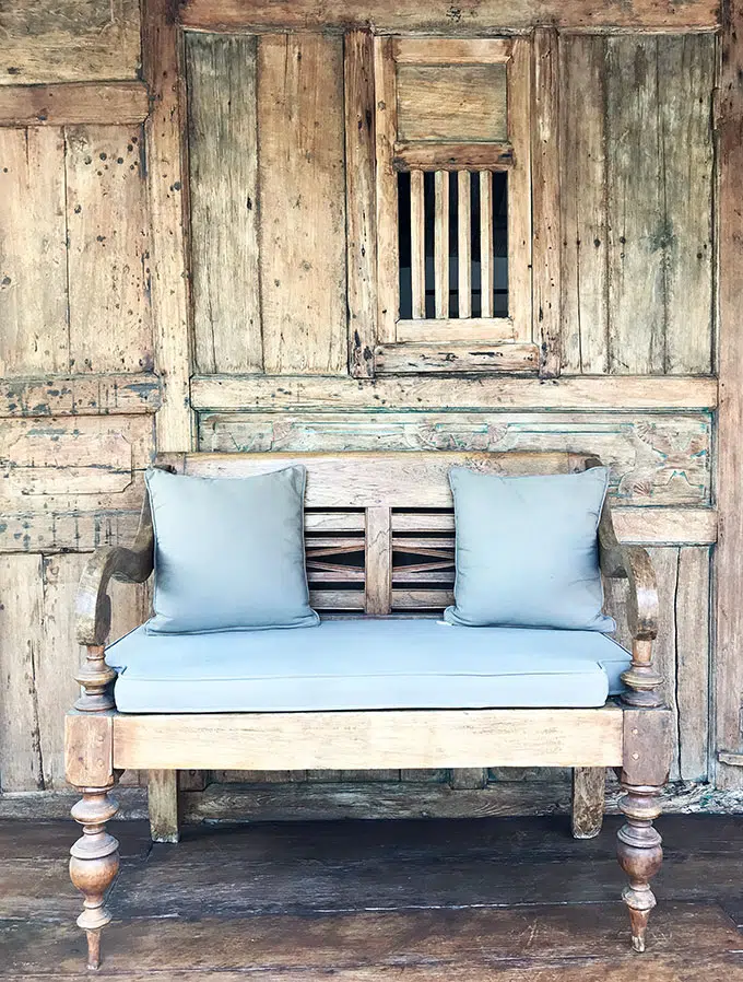 chair on deck in front of wooden cabin