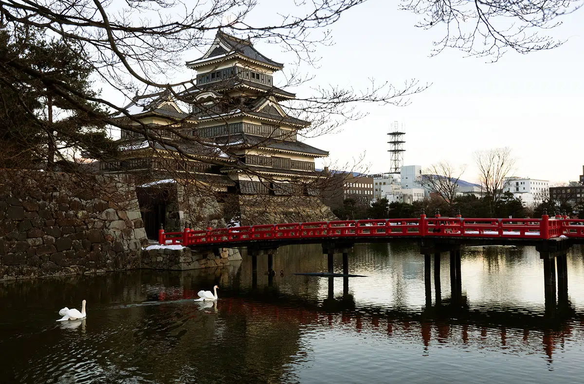 the castle, moat and a red bridge