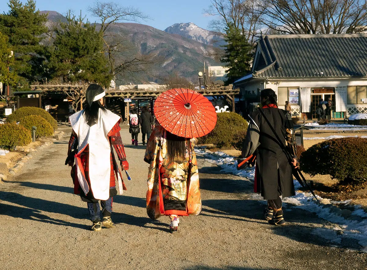 three people dressed in period costume in walking