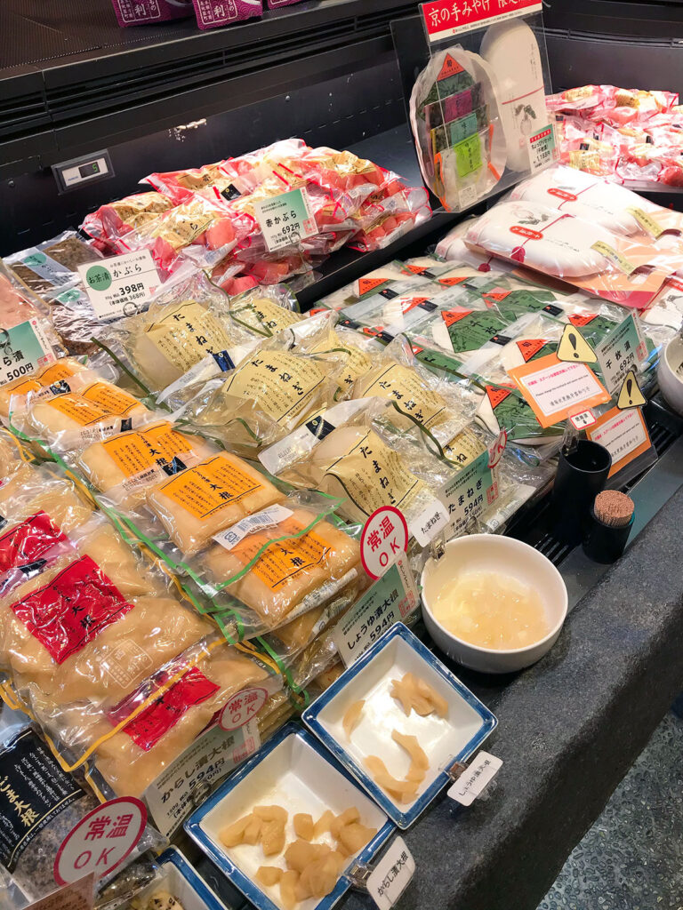 various pickled daikon products individually wrapped for sale at nishiki markets