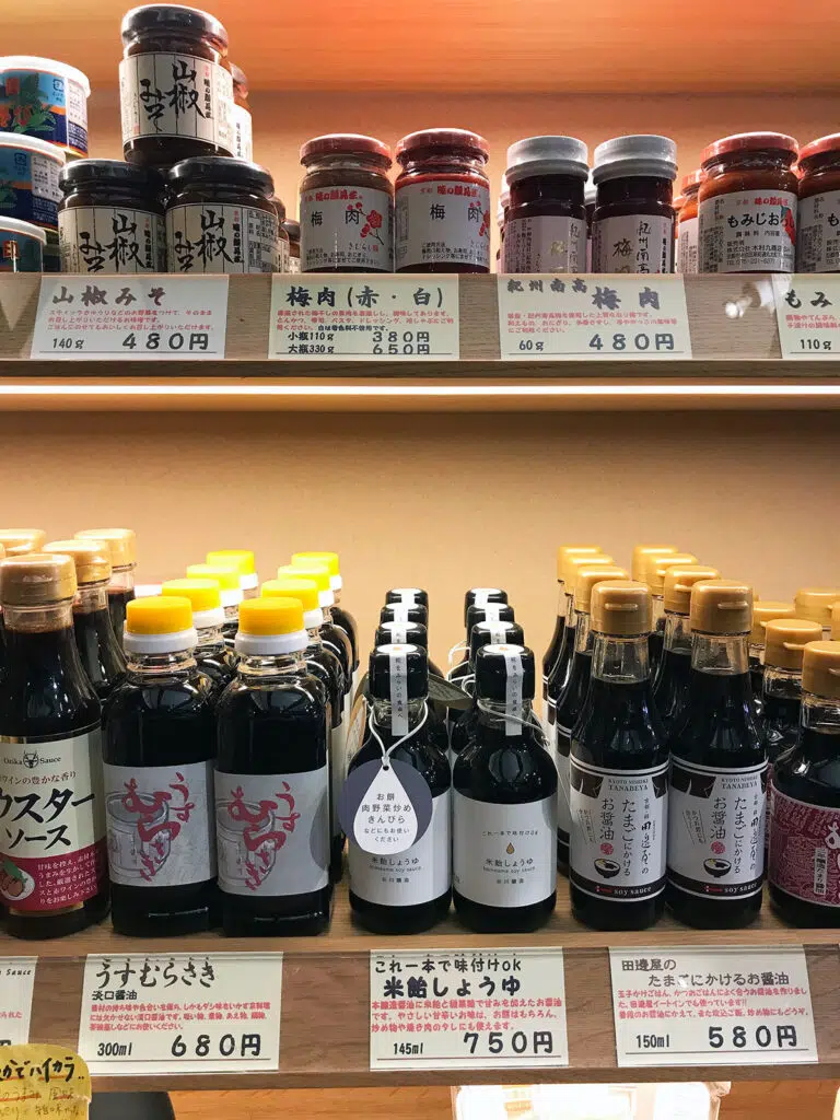 various jars and bottled of soy sauce and pastes on a shop's shelves