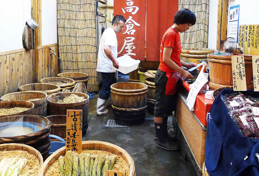 people preparing pickles in their shop